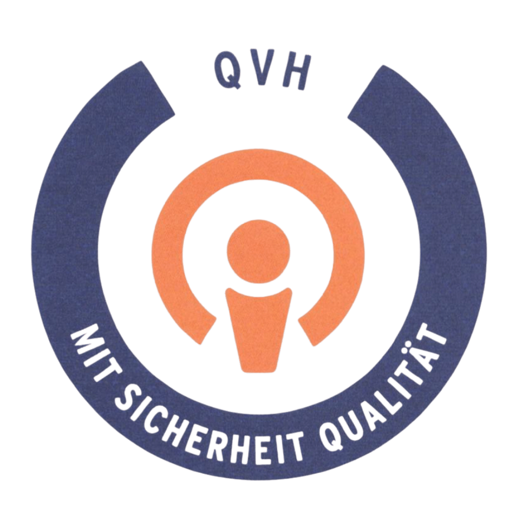 Rundes Qualitätssiegel mit der Aufschrift „QVH – Mit Sicherheit Qualität“. Das Logo steht für den Qualitätsverbund Hilfsmittel und zeigt, dass der Betrieb geprüfte Qualitätsstandards in der Hilfsmittelversorgung einhält.