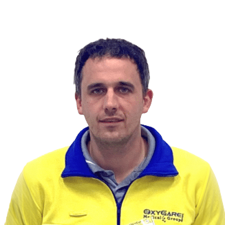 Foto von Oliver Schob, Mitarbeiter von OxyCare. Er trägt ein gelbes Hemd mit dem OxyCare Logo und schaut freundlich in die Kamera.
